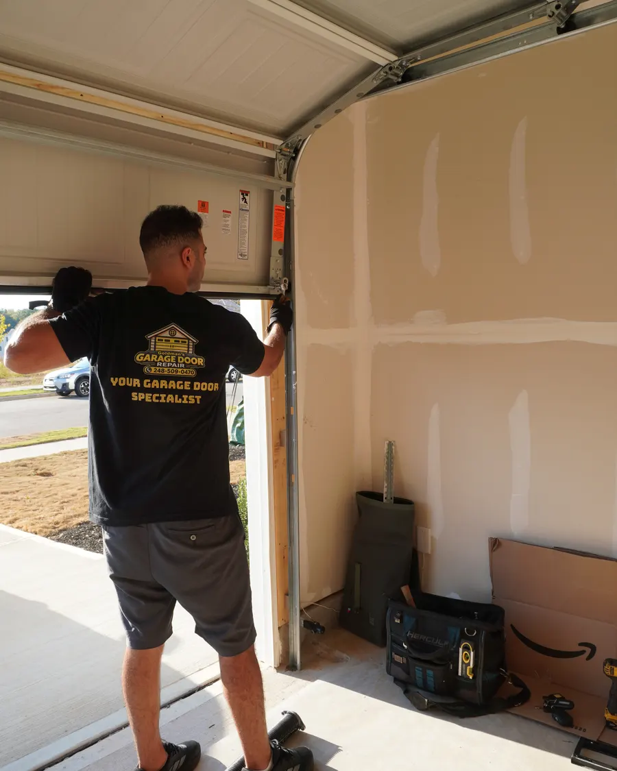 Goldman’s technician repairing a garage door
