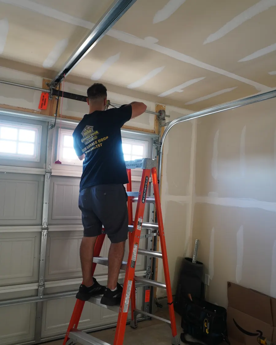Goldman’s technician adjusting garage door springs
